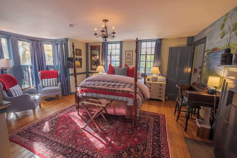 The Charles Morgan Guest Room is beautifully decorated in jewel-tone colors inspired by the Captain's Quarters of the whaling ship itself! 