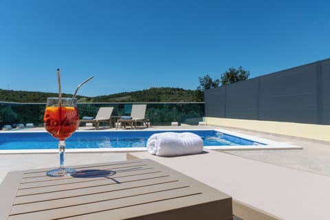 Outdoor pool, a heated pool, open open 24 hours, pool umbrellas
