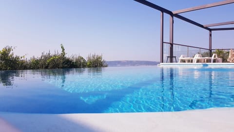 Outdoor pool, an infinity pool, sun loungers