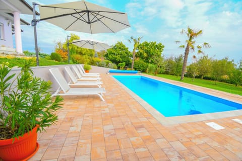 Outdoor pool, a heated pool, open open 24 hours, pool umbrellas