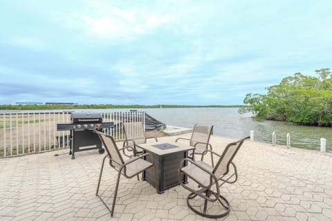Your private waterfront patio with comfortable seating and BBQ grill offers stunning lake views for memorable outdoor dining experiences.