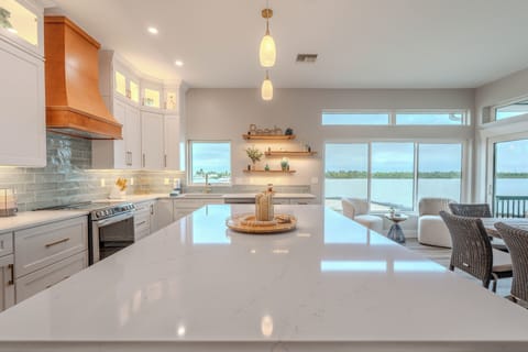 Your gourmet kitchen features gleaming quartz counters and stunning water views that make cooking feel like a dream.