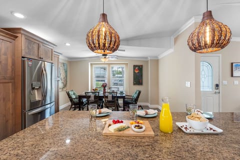 Cook with ease in a well-designed kitchen featuring granite countertops, tile backsplash, and deep sink overlooking the yard.