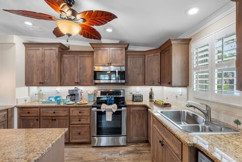 Enjoy a spacious, fully stocked kitchen complete with pendant lighting, a large island, and plenty of prep space for group meals.