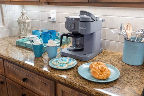 Enjoy morning coffee at the beautifully crafted island while natural light fills the room through plantation-shuttered windows.