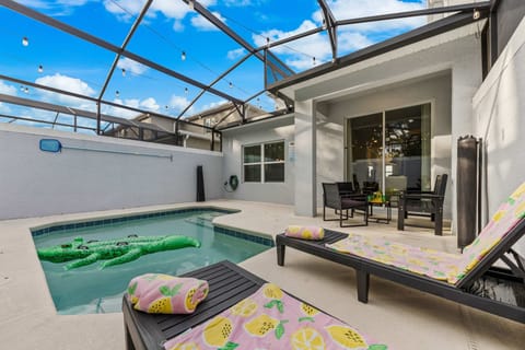 Dive into your private screened-in pool under twinkling string lights. Loungers and a covered patio make this sunny lanai perfect for relaxing between adventures!