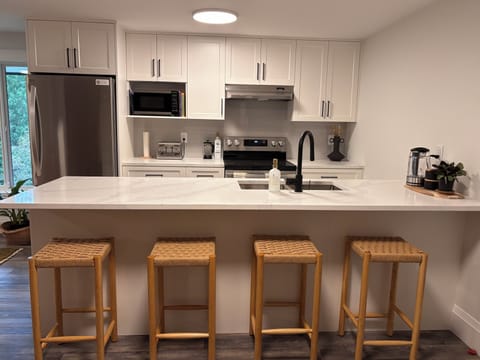 Bar seating near full kitchen. 