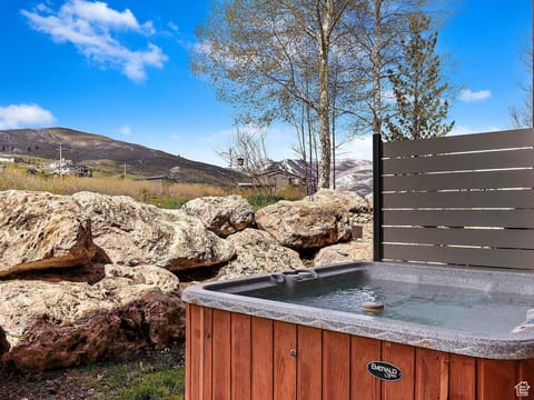 Relax in the private hot tub overlooking the mountains