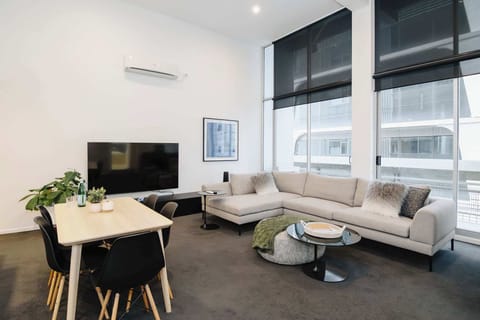 Open Plan lounge room with huge comfy sofa leading onto the balcony and kitchen. Perfect for entertaining and meals with friends and family. 