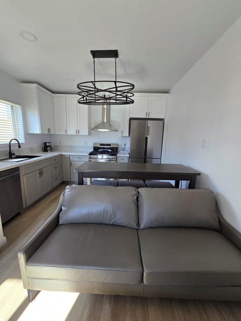 Open concept living and dining area. Genuine leather sofa.