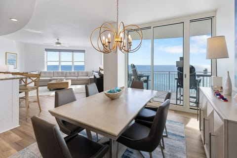 Gather around your elegant dining table while soaking in breathtaking ocean views through floor-to-ceiling windows.