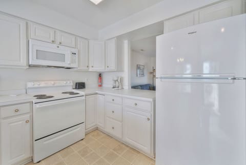Kitchen is beachy and bright white - crisp and clean.