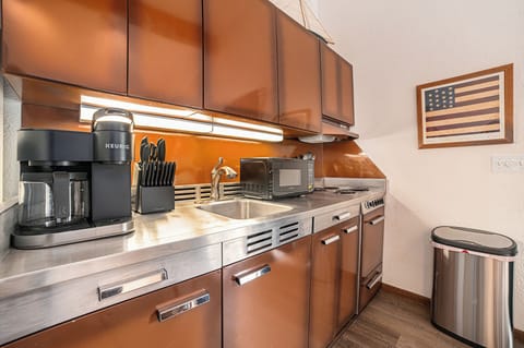Kitchen with coffee, basic spices, utensils, cookware, and kitchen basics.