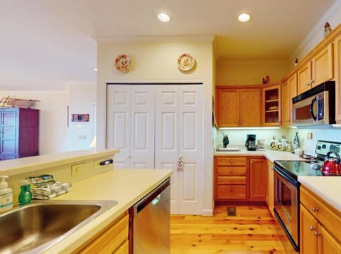 Your fully-equipped kitchen welcomes home-cooked meals with warm wood cabinets, modern appliances, and everything you need for memorable vacation dining.