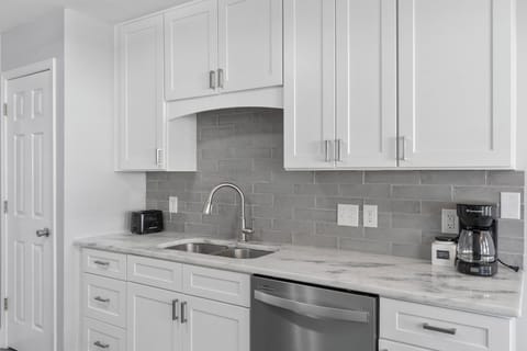 Sleek lines, polished counters, and modern fixtures give this kitchen a bright, upscale feel. From the full-size oven to the built-in microwave and ample prep space, it's ready for all your cooking adventures—big or small.