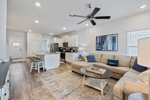 Serenity - 14330 Garden Glen by PKRM - Downstairs living area, half bath, kitchen, dining and ensuite primary bedroom 1.