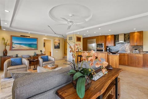 Unwind in an elegant living space, where rich wood tones and thoughtful design create your perfect island retreat.