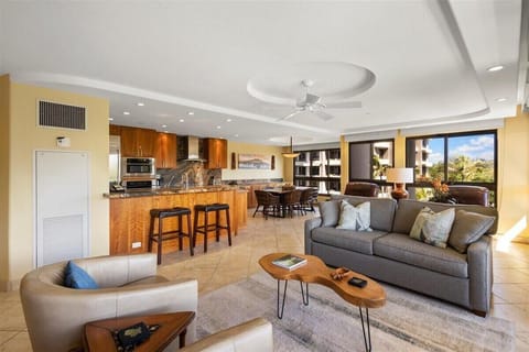 Unwind in your spacious, light-filled living area, where indoor comfort seamlessly flows into tropical outdoor beauty.