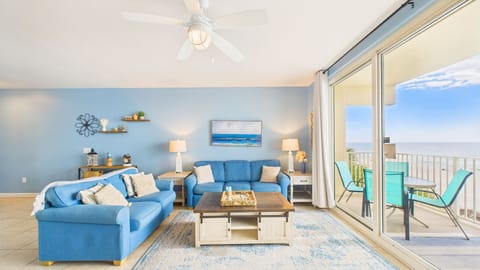 Relax in your coastal-themed living room featuring an ocean-blue sleeper sofa, nautical décor, and a rustic coffee table—perfect for family gatherings.
