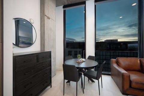 Luxury living room on the 11th floor with amazing views of downtown and mountains. Local original art and a 65” Roku tv.