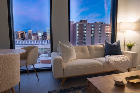 Luxury living room on the 10th floor with amazing views of downtown and mountains. Local original art and a 65” Roku tv.