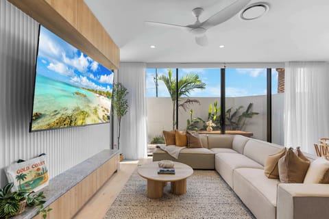 Spacious Japandi-inspired lounge featuring a large L-shaped sofa, warm timber finishes, and a calm, minimalist design.