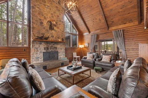 Escape to our stunning lodge, featuring soaring cathedral ceilings, rich wood finishes, and a massive stone fireplace that defines mountain luxury. This magnificent living area is the perfect gathering spot for making unforgettable memories