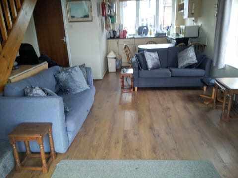 Living room with 2x2-seat sofas, leather arm chair, foot stool and casual tables