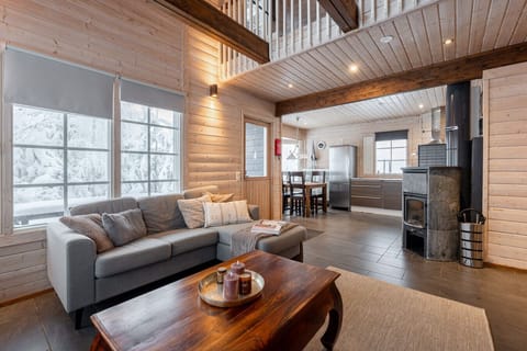 The spacious living room is the heart of the home, where high ceilings and large windows create a sense of airiness.