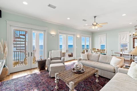 Sink into plush sofas while ocean breezes flow through your coastal living room, where panoramic sea views create the perfect backdrop for relaxation.