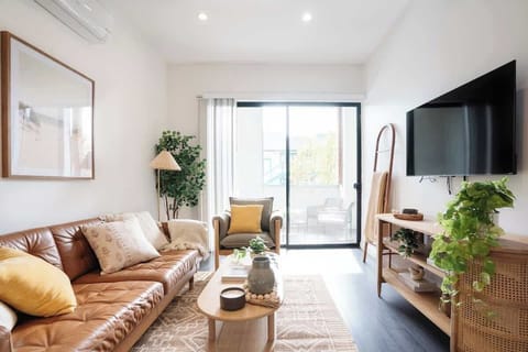 Slide open the floor to ceiling glass doors to create a seamless indoor/outdoor space