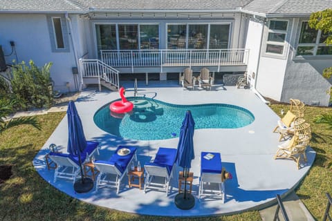 Outdoor Oasis: Dive into relaxation by the shimmering pool, surrounded by chic seating and sun!