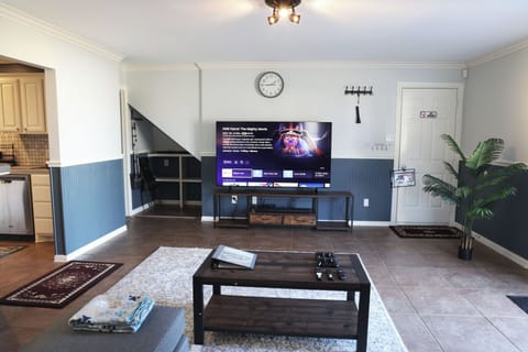 Spacious open studio with sectional sofa, king bed, and full kitchen.