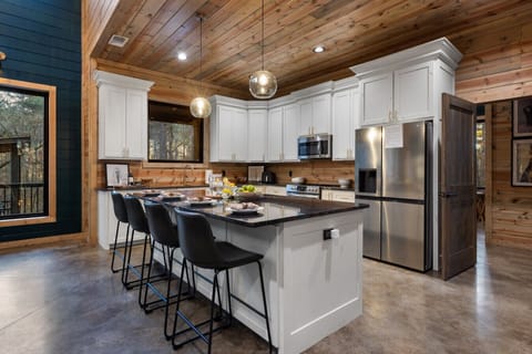 Our spacious kitchen is built for groups, featuring a massive island and extra folding tables to ensure your entire party can enjoy a sit-down meal together.