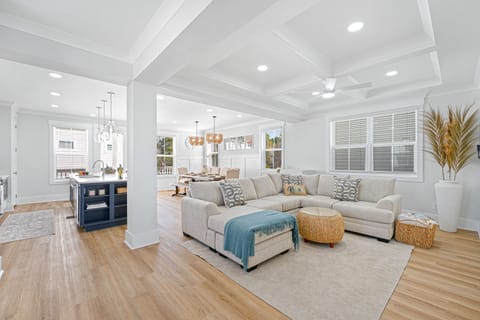 An open floor plan seamlessly connects the living areas, bathed in light from expansive windows