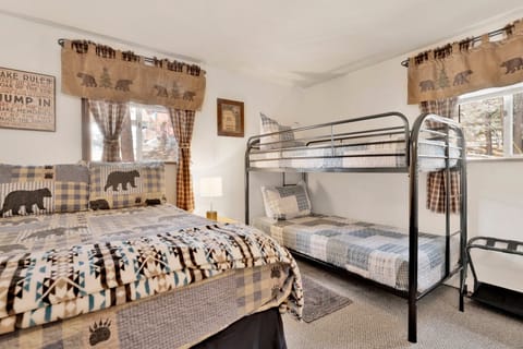 Peaceful cabin bedroom with plush bedding, and beautiful views—ideal for restful nights, cozy mornings, and a relaxing mountain escape.