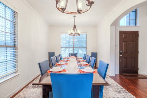 Bright formal dining room with seating for a group and elegant lighting