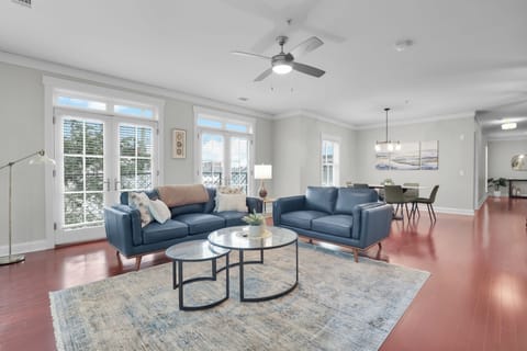 Spacious open living and dining area with modern décor, large windows, and natural light.