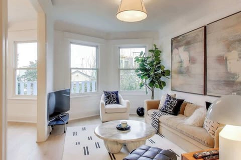 The spacious living room opens to the dining room and has a view of the shared back yard garden.