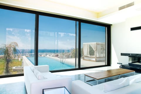 Deluxe Villa, Sea View | Living area | 55-inch Smart TV with satellite channels, fireplace