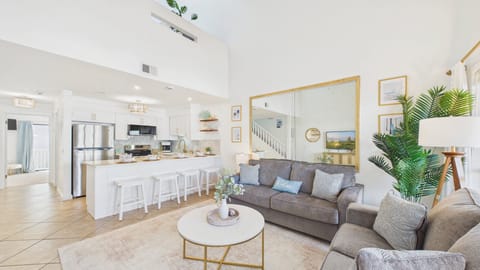 The open concept floor plan flows seamlessly into the living area with ample seating and stylish decor