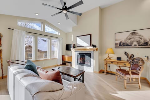 Unwind in your spacious living room with cozy fireplace, vaulted ceilings, and peaceful neighborhood views through oversized windows.