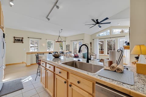 Your open-concept kitchen flows seamlessly into the living space, where you'll love preparing meals with granite counters and warm wood cabinetry.