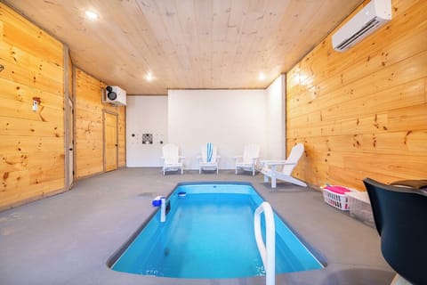 Dive into your private indoor pool surrounded by warm wood walls and comfortable seating—perfect for year-round relaxation.