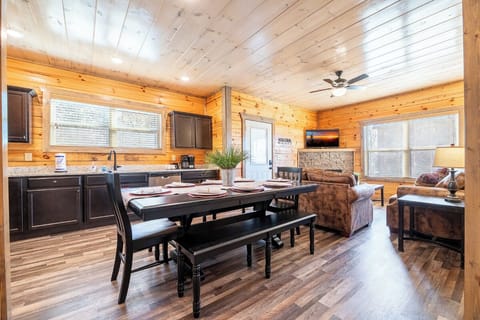 Your rustic cabin retreat features warm log walls and an open-concept layout where you can cook, dine, and relax together.