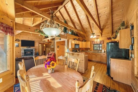 Gather around this warm wooden dining table where family meals become cherished memories beneath soaring cathedral ceilings.
