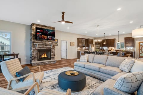 Living Room 1: Relax by the fire: comfy seating, warm vibes, and a large TV. 