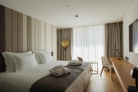 Unwind in a bright, modern bedroom with cozy robes.