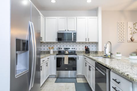 Modern kitchen with sleek appliances and granite countertops