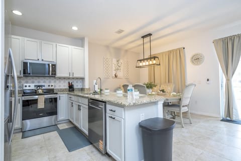 Modern kitchen with sleek appliances and spacious island seating